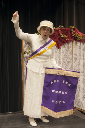 A woman dressed as a historical character for the woman's suffrage movement.