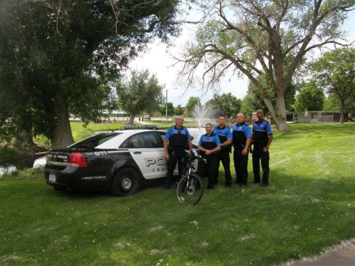 Impact Team Standing in front of a police vehicle.