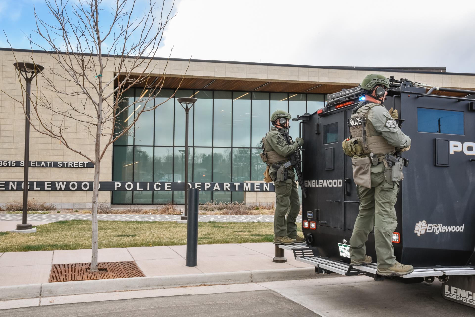 Officers on the back of the bearcat vehicle