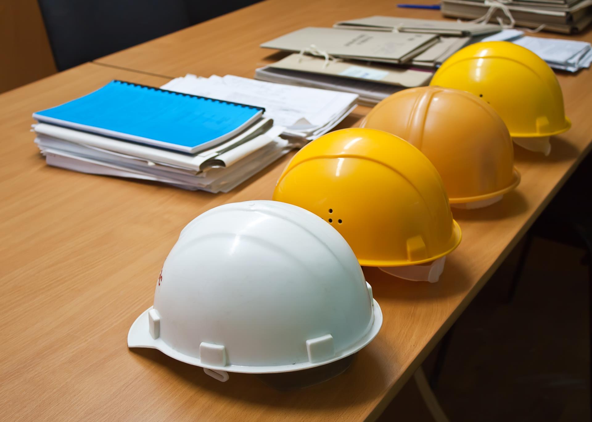 Hard hats and Books on a Table