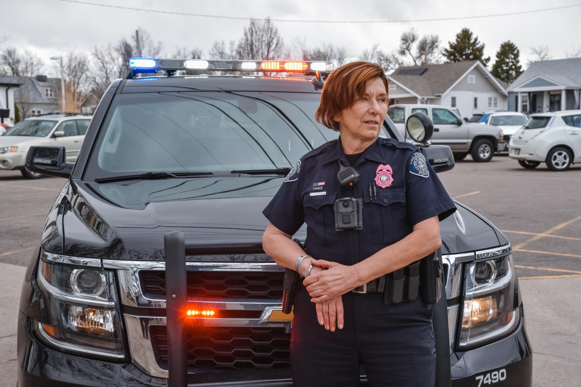 Female Police Officer in Front of a Police Car