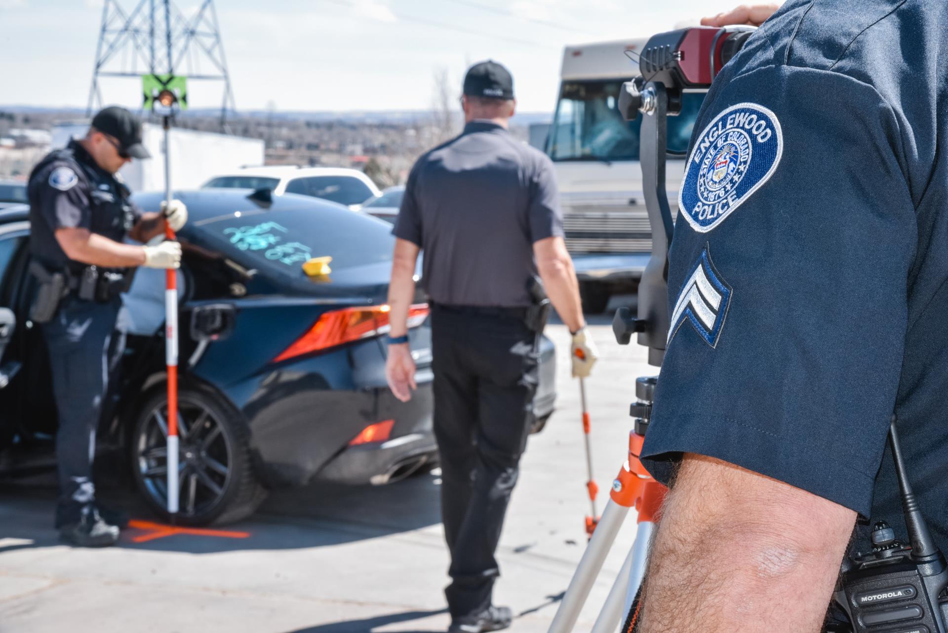 One police officer observing two other police officers